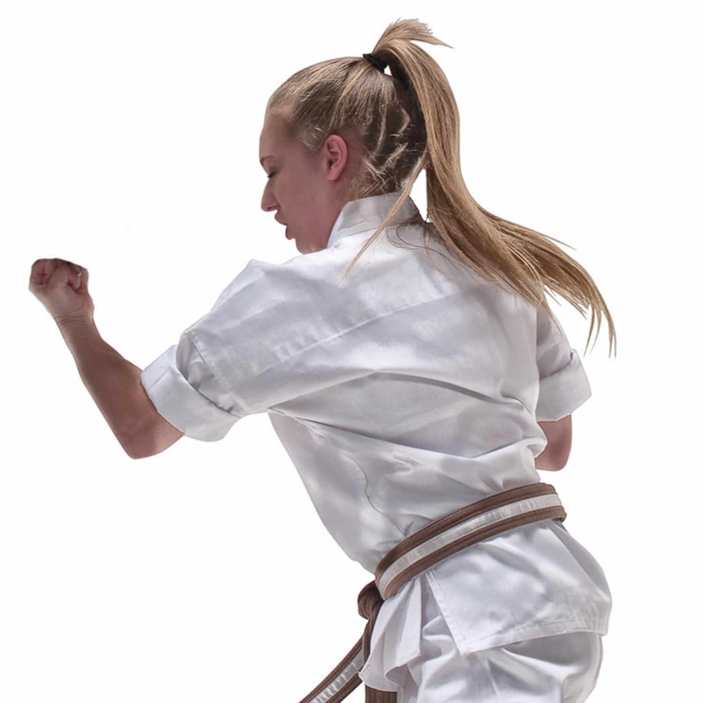 Young martial artist wearing a MACHO traditional middleweight karate jacket in action.