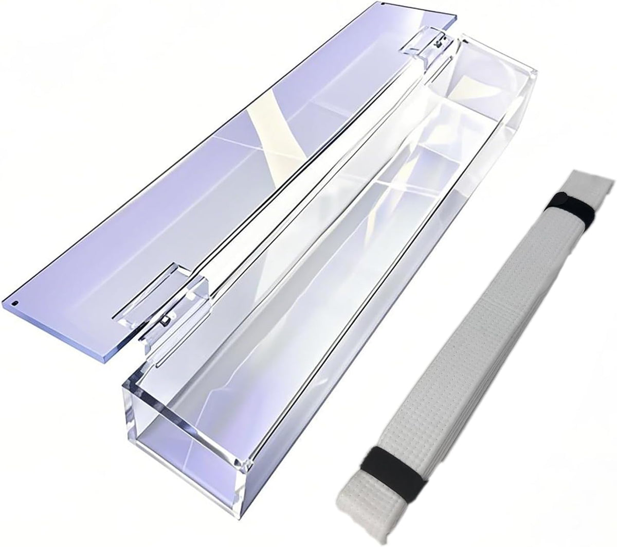 Clear acrylic martial arts belt display case with hinged lid and compartments holding a white belt with black straps